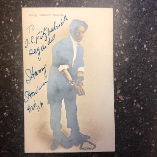 1301450 AUTOGRAPHED POSTCARD OF HOUDINI [In hand and leg cuffs]. Harry Houdini