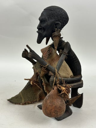 MAKONDE CARVED WOOD MALE FIGURE SEATED ON STOOL WITH FIBER CLOTH, KENYA