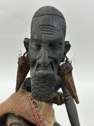 MAKONDE CARVED WOOD MALE FIGURE SEATED ON STOOL WITH FIBER CLOTH, KENYA